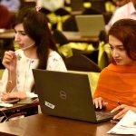 Women are actively engaged in work during a Property Sale Event hosted at a local hotel