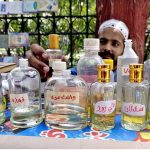 A vendor is displaying different perfumes to attract the customers at his roadside setup near Jinnah bagh