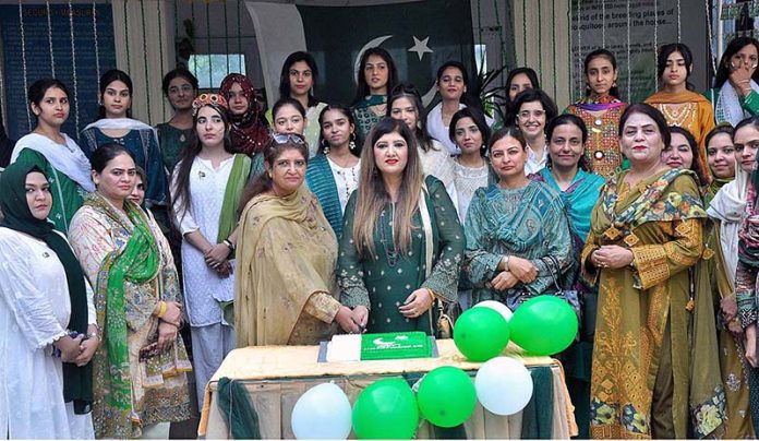 Professor Dr. Fariha Nighat along with the Students cutting cake on the occasion of 77th Independence Day celebration at Government College for Women Dhoke Elahi Bakhsh