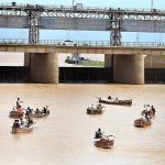 Fisherman catching fishes on their boats at Indus river