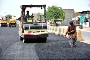 Laborers busy in construction work of Mohen-jo-Daro Airport Road during development work in the city