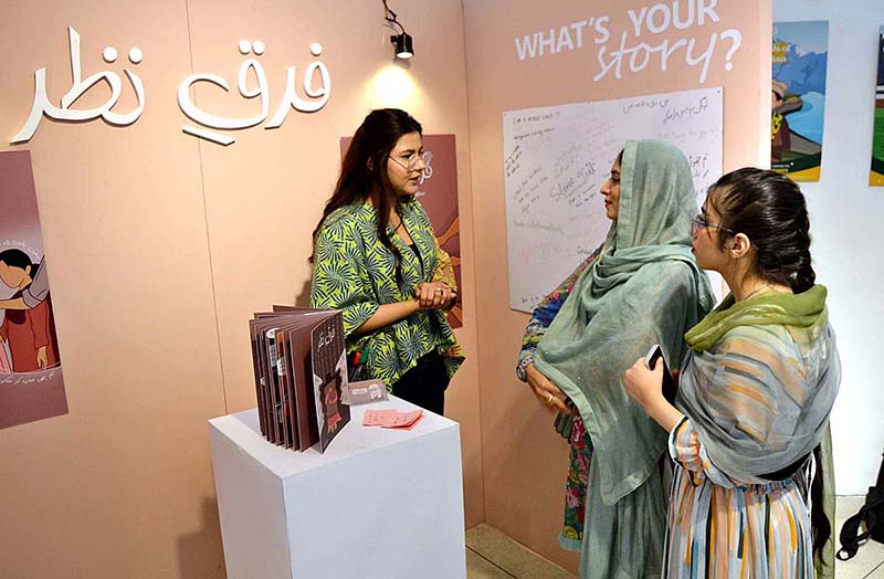 Student from department of Graphic Design Lahore College Women University are briefing the visitors about the Cordeli Degree Show 2023 BFFA Graphic Design at Alhamra Art Gallery