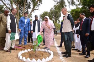 First Lady Begum Samina Arif Alvi along with President Dr. Arif Alvi watering a Mango sapling after planting at Mizar-e-Quaid
