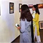 Visitors viewing photo exhibition entitled "Expression of Art, Culture and History through the Eye of a Camera held at the Al Hamra Event Air Theater Gallery