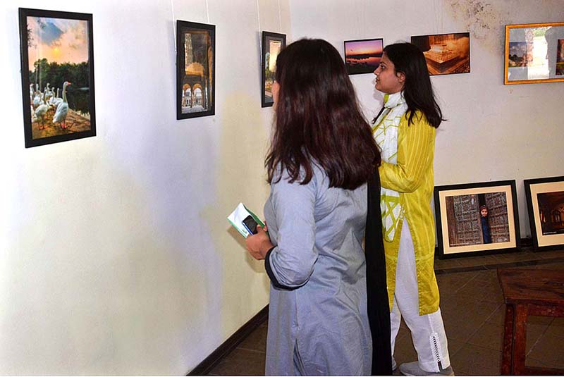 Visitors viewing photo exhibition entitled "Expression of Art, Culture and History through the Eye of a Camera held at the Al Hamra Event Air Theater Gallery