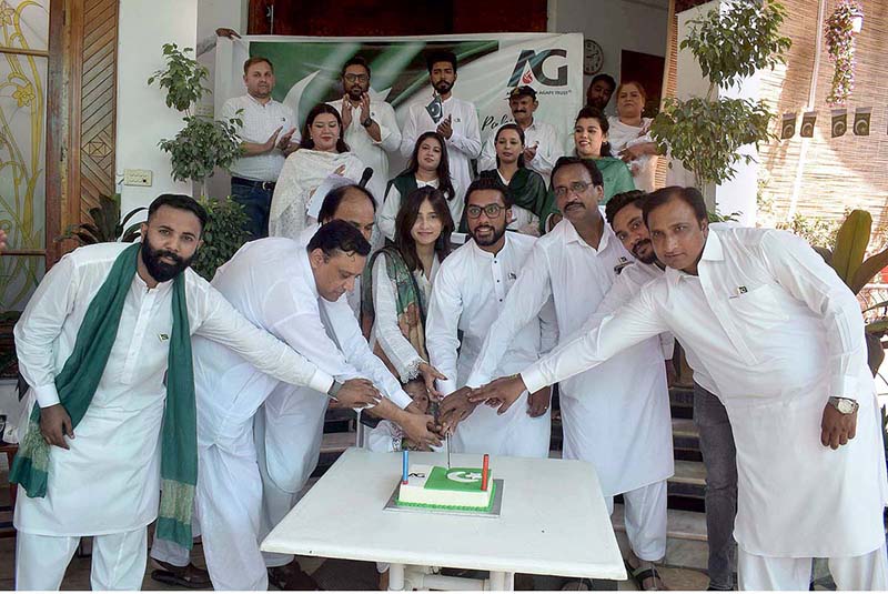 Youngsters are holding flags displayed by a vendor at the roadside, aiming to attract customers as the nation begins preparations to celebrate Independence Day with fitting celebrations