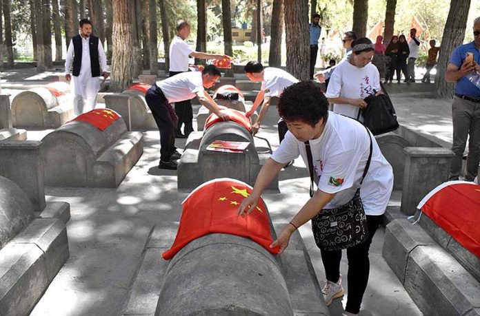 Chinese delegation paying tribute to their relatives who loss their lives during the construction of Karakoram Highway (1959-77) during their visit to Chinese Graveyard Daniyor