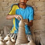A craftsman busy in preparing clay-made stuff at his work place in Kumhar para at Jamshoro road