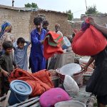 Residents of kacha area near Indus River keeping household goods in a safe area at Saharash Nagar near Indus river