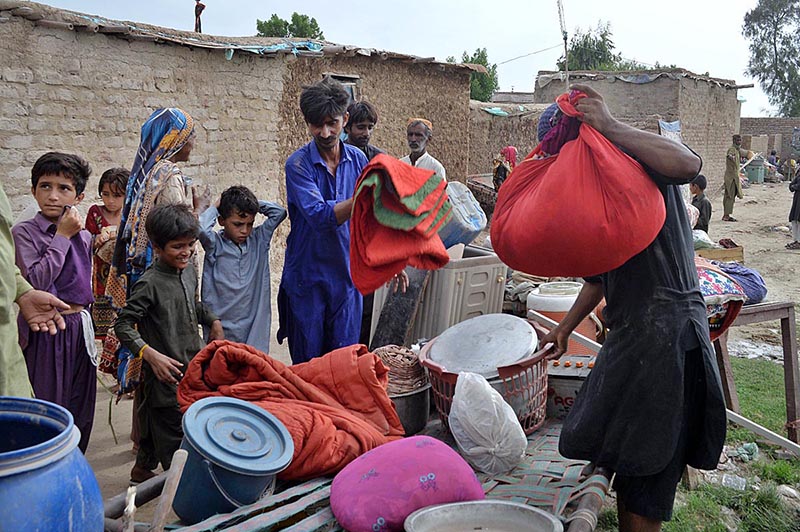 Residents of kacha area near Indus River keeping household goods in a safe area at Saharash Nagar near Indus river