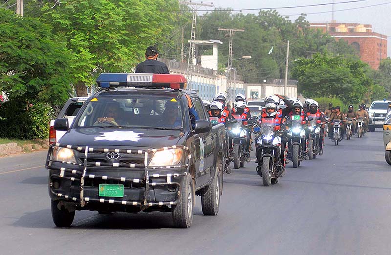 A view of security personnel holding flag march to develop a sense of protection among the masses and maintain law and order situation