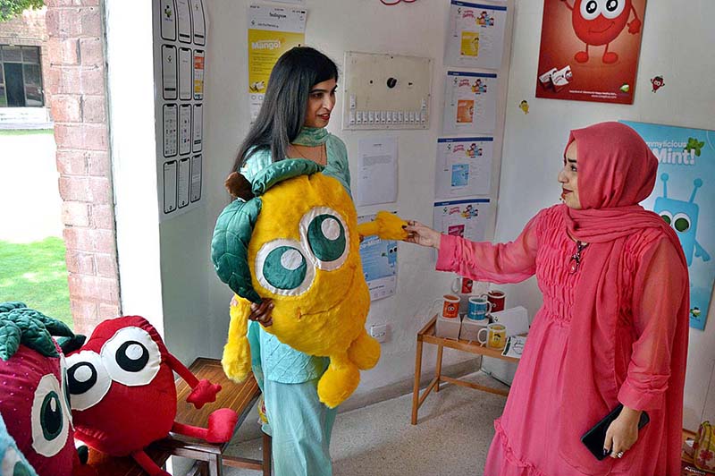 Student from department of Graphic Design Lahore College Women University are briefing the visitors about the Cordeli Degree Show 2023 BFFA Graphic Design at Alhamra Art Gallery
