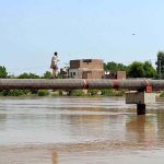 A gypsy crossing Phuleli canal on water supply pipeline at Tandi yosuf