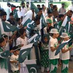 Children are reciting the National anthem and waving the National flag during Flag hoisting ceremony at Punjab Assembly on the occasion of 77th Independence Day celebration