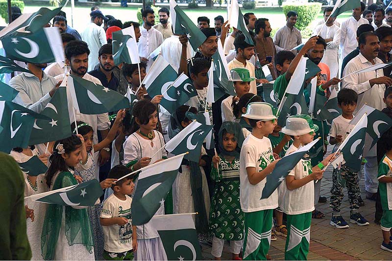 Children are reciting the National anthem and waving the National flag during Flag hoisting ceremony at Punjab Assembly on the occasion of 77th Independence Day celebration