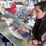 Student giving final touch to her painting in the training class at Peshawar Morr Weekly Bazar