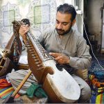 Worker busy in making traditional musical instrument (Rabab) at his workplace in the Dabgari area.