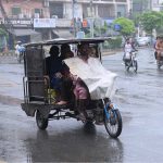 Vehicles on their way after rain in the provincial capital