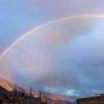 An attractive and eye catching view of rainbow during rain in city
