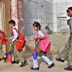 Students are going to their school for the first day after the summer vacation