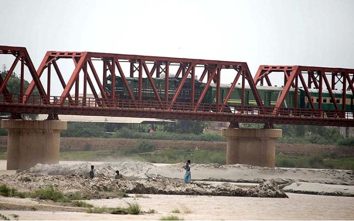 A passenger train on the way passing through Kotri Railway Bridge A passenger train on the way passing through Kotri Railway Bridge