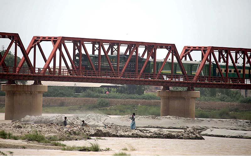 A passenger train on the way passing through Kotri Railway Bridge