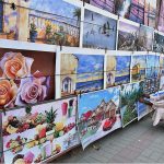 A vendor displaying and selling beautiful poster pictures on the wall to earn a livelihood for children in the city