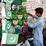 A vendor displaying national flag and other stuff to attract the customers in connection with upcoming Independence Day celebrations