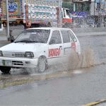 A car passing through water during rain that experiences in the city