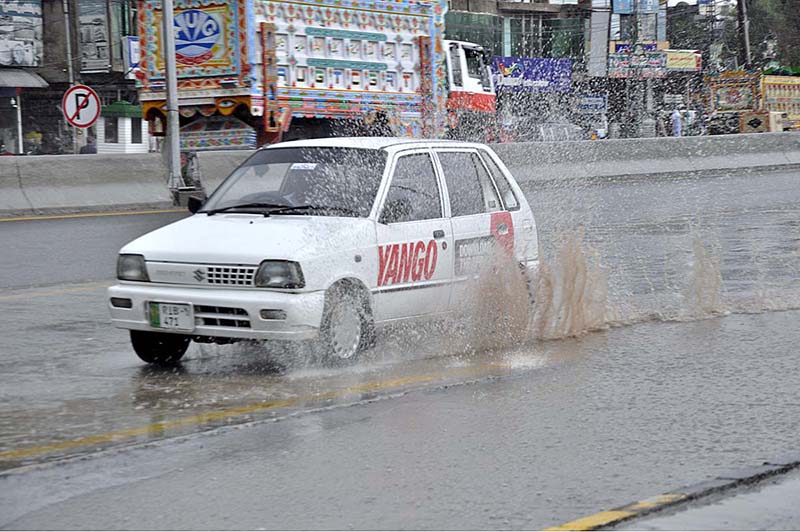 A car passing through water during rain that experiences in the city