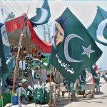 Vendors displaying national flags to attract the customer's in preparation of upcoming Independence Day celebration of Pakistan
