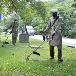 CDA worker trimming grass at greenbelt during beautification work of the city