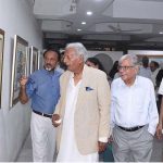 Renowned Dramatist Mustansar Hussain Tarar is looking at the water painting during exhibition at the Art Gallery