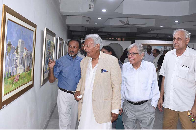 Renowned Dramatist Mustansar Hussain Tarar is looking at the water painting during exhibition at the Art Gallery