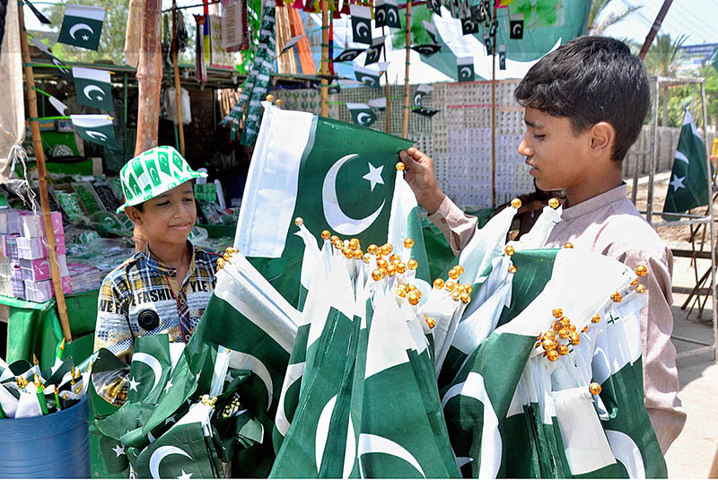 Vendors displaying national flags to attract the customer's in preparation of upcoming Independence Day celebration of Pakistan