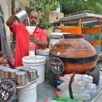A vendor selling traditional summer drink (Lassi) at front of Company Bagh