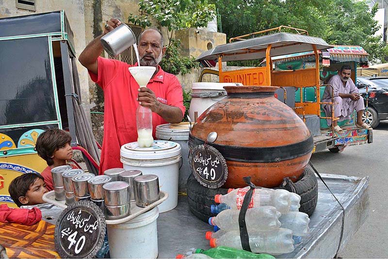 A vendor selling traditional summer drink (Lassi) at front of Company Bagh