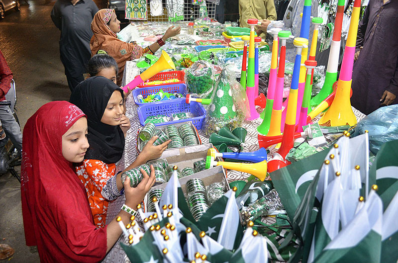 Children busy in purchasing bangles and other stuff at Latifabad road in preparations to celebrate Independence Day in befitting manners