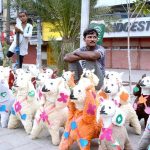 Roadside vendor displaying toys to attract customers at his roadside setup