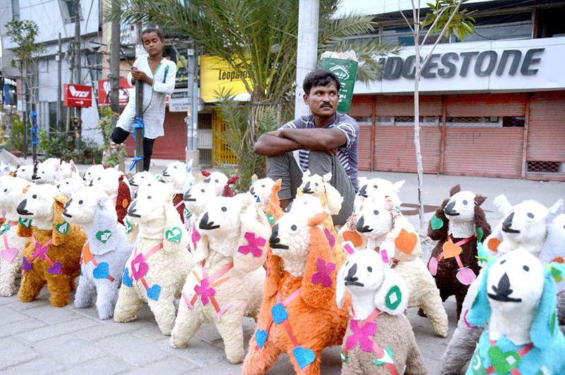 Roadside vendor displaying toys to attract customers at his roadside setup