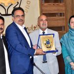 President Chamber of Commerce Abdul Ghafoor Malik presenting a shield to Farrukh Amil Chairman Intellectual Property Organization of Pakistan