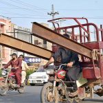 A tricycle rickshaw holder on the way loaded with irin bars at Nori Gate