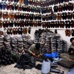 Cobblers preparing traditional shoes (Peshawari Chappal) at his workplace