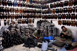 Cobblers preparing traditional shoes (Peshawari Chappal) at his workplace