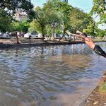 Youngsters diving into canal to bathe in the rising heat and humid weather in the city