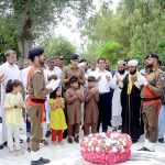 DPO Attock Dr Sardar Ghiyas Gul Khan, DC Attock Rao Atif Raza and the families of the martyrs are praying after laying flowers on the monument of the martyrs