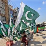 Vendor displaying National flags to attract the customers as the nation starts preparations to celebrate Independence Day in befitting manners at roadside