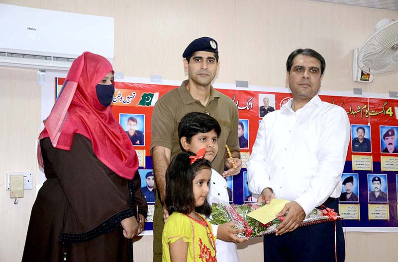 DC Attock Rao Atif Raza presenting flowers and funds to the families of the martyrs on the occasion of Martyrs Day ceremony at Police Line