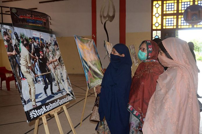 Women taking keen interest during painting exhibition to mark the Kashmir Day of Exploitation organized by the Arts Council