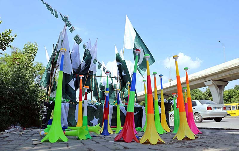 Vendor displaying National flags to attract the customers as the nation starts preparations to celebrate Independence Day in befitting manners at roadside